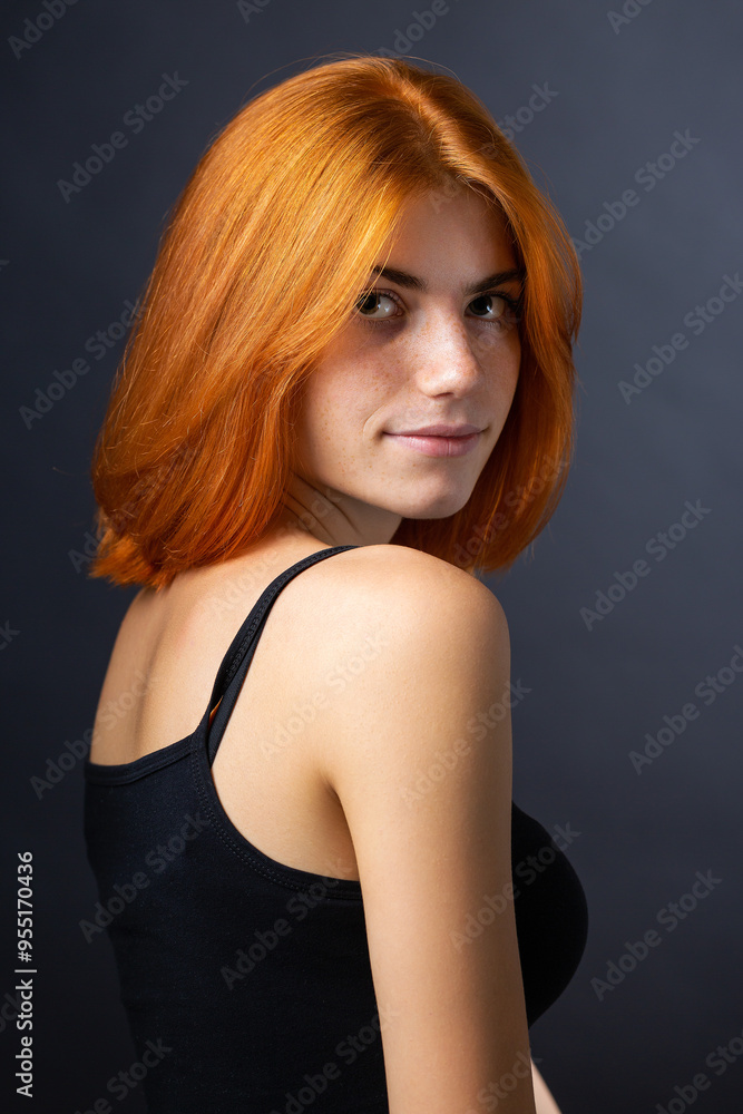 Cute red-haired girl, studio portrait on a black background. Cute red-haired girl, studio portrait on a black background.