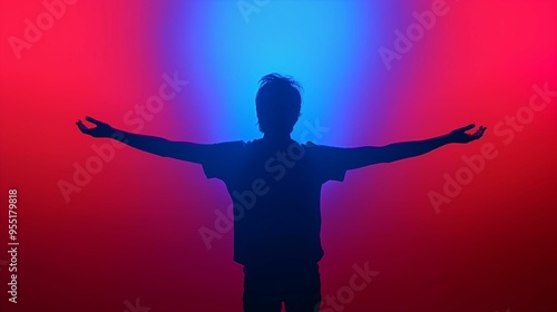 Silhouette of a person with arms raised against red and blue gradient background.