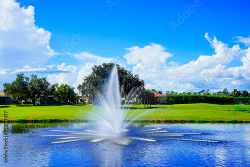 Florida blue sky, lake, fountain and house