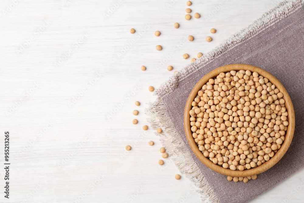 Dried peas in bowl on light wooden table, top view. Space for text Dried peas in bowl on light wooden table, top view. Space for text