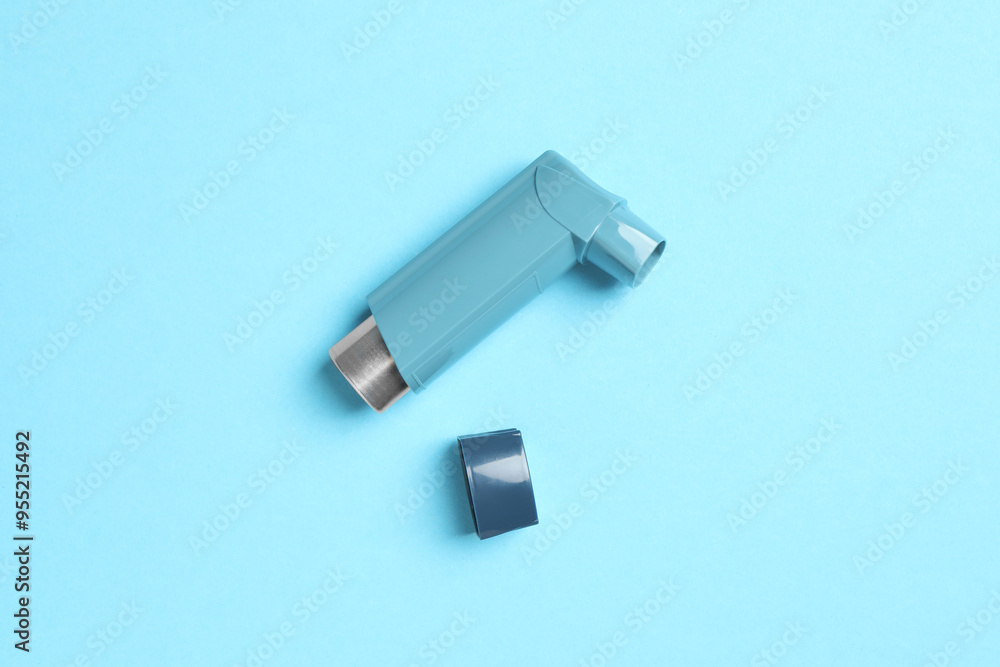 Asthma inhaler on light blue background, top view Asthma inhaler on light blue background, top view
