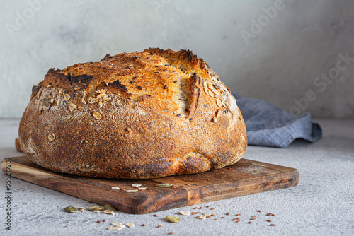 Fresh homemade bread (slice) from whole grain sourdough flour with the addition of bran, seeds (sunflower, pumpkin, flax, sesame) and oatmeal flakes. Healthy food. High quality photo. photo