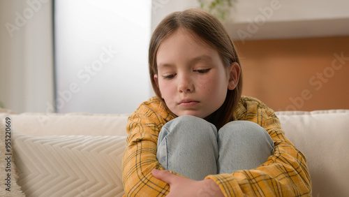 Fotografie Stressed unhappy sad pensive Caucasian kid little girl feeling frustrated depres