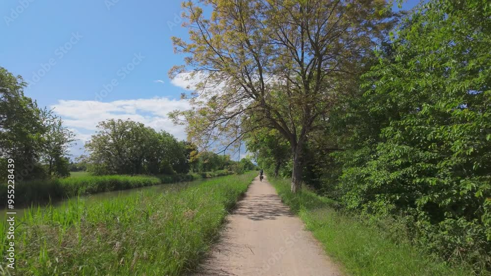 Riding Along Spring Greenery next to French Canal Riding Along Spring Greenery next to French Canal