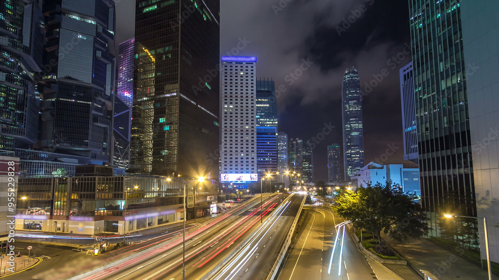 Hong Kong Business District with busy traffic timelapse at night. Hong Kong Business District with busy traffic timelapse at night.