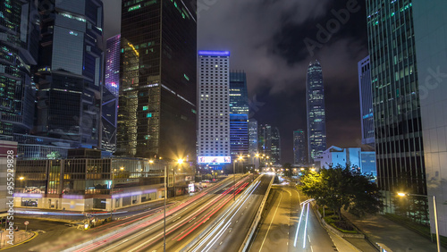 Hong Kong Business District with busy traffic timelapse at night. photo