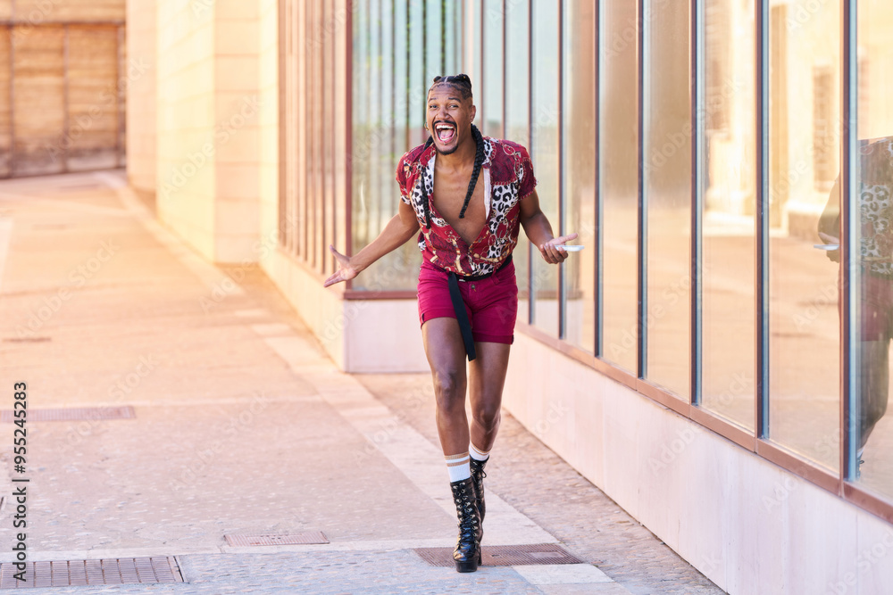 A gay man with braids talks on his cell phone. He smiles and makes a funny face A gay man with braids talks on his cell phone. He smiles and makes a funny face