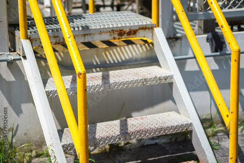 Bilde på lerret Refinery plant and oil storage metal walkway-stair platform with yellow handrail or banister rail part