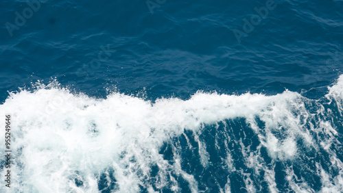 Aerial view to ocean waves. Blue water background