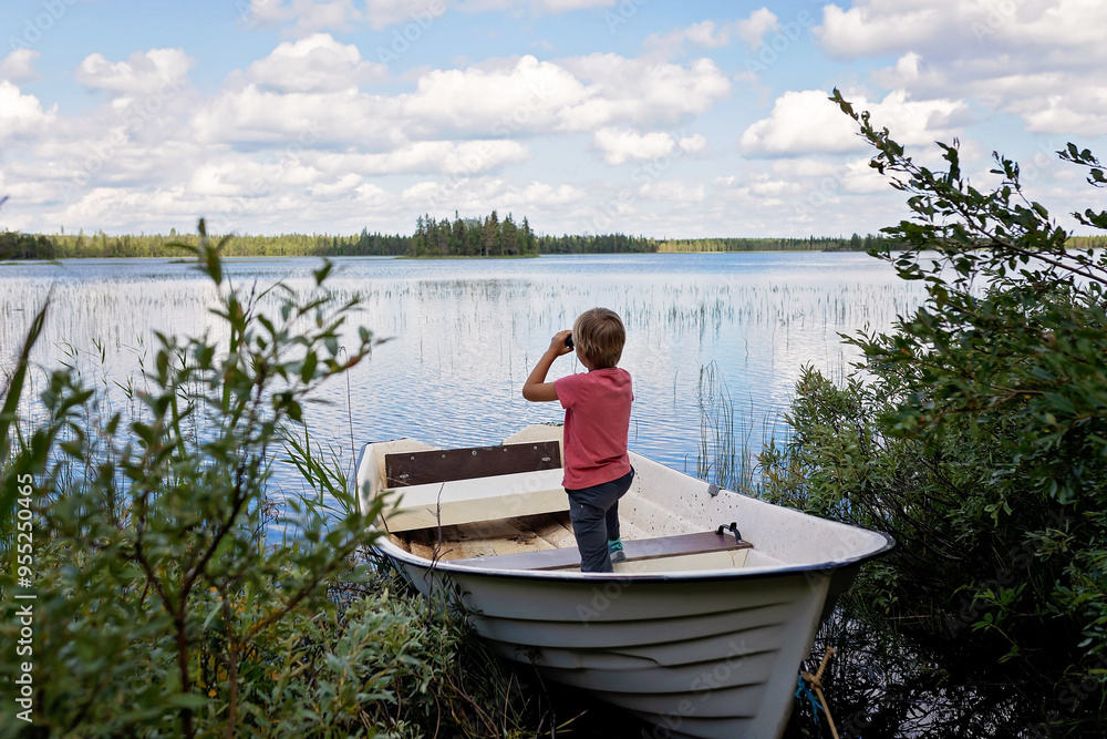 Children, playing on a boat in a river, summertime, watching nature with binoculars, sunny weather Children, playing on a boat in a river, summertime, watching nature with binoculars, sunny weather