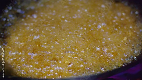 A detailed close-up shot of hot oil bubbling in a frying pan, ideal for culinary cooking and food preparation themes.