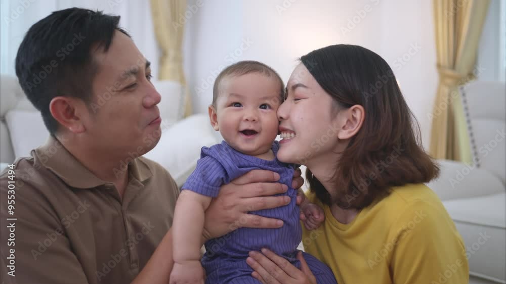 Parents and their little child play happily in the living room of the house Parents and their little child play happily in the living room of the house