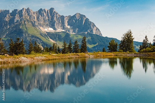 Alpine summer view with reflections and Mount Wilder Kaiser at Mount Astberg, Going, Kitzbuehel, Tyrol, Austria photo