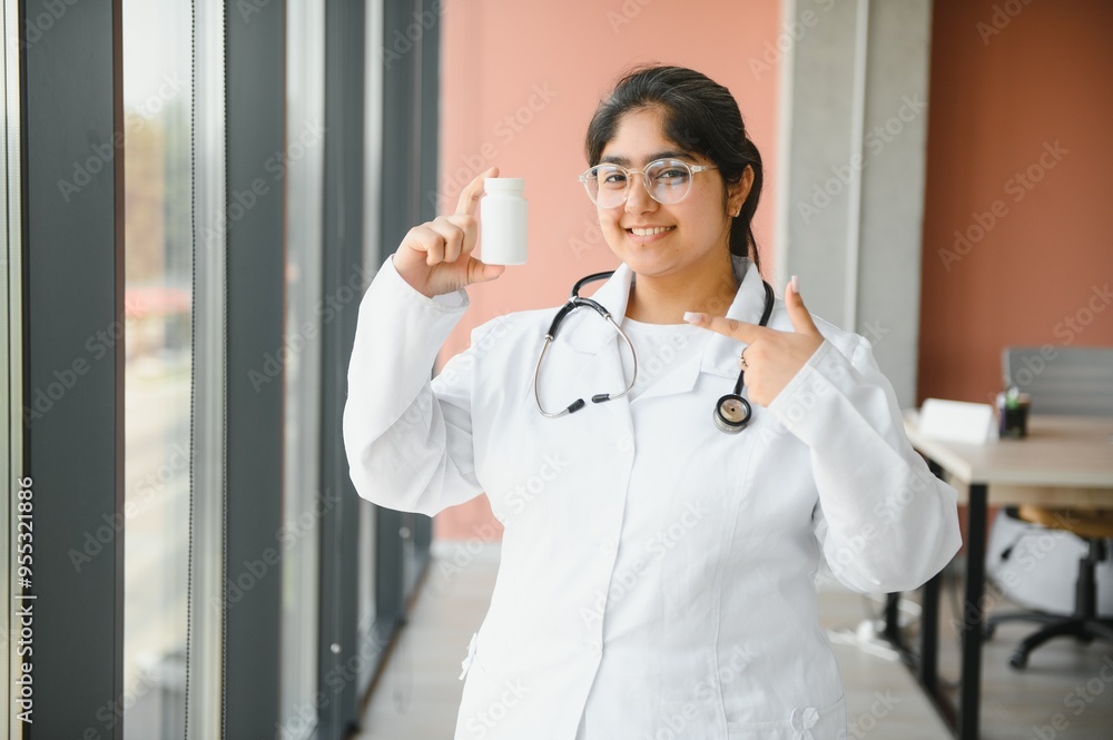 Portrait of a young indian female doctor holding medicine tablet pills Portrait of a young indian female doctor holding medicine tablet pills