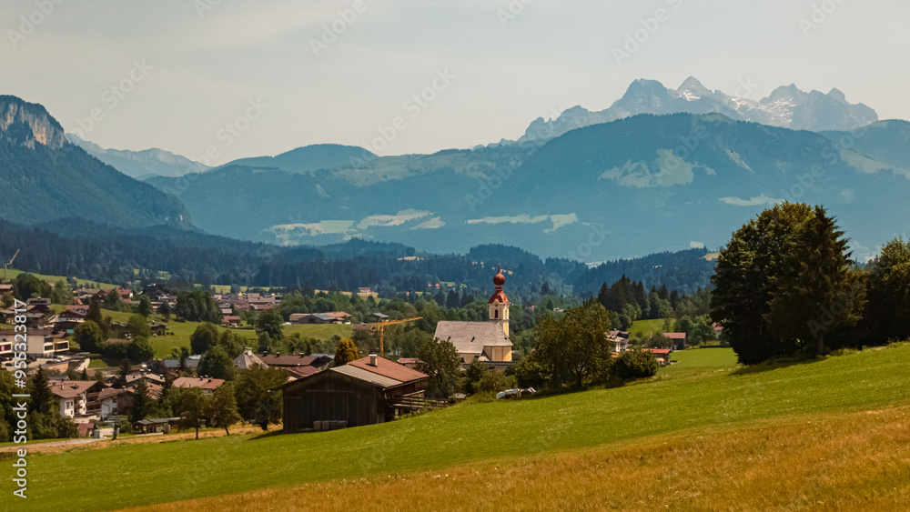 Alpine summer view with a church and the Loferer Steinberge Mountains seen from Going, Kitzbuehel, Tyrol, Austria Alpine summer view with a church and the Loferer Steinberge Mountains seen from Going, Kitzbuehel, Tyrol, Austria