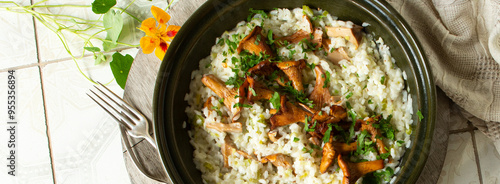 ceramic dish with risotto with chanterelles on a light table