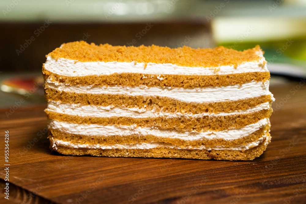 Honey cake Medovik, layer cake on wooden background. Closeup view. dessert Honey cake Medovik, layer cake on wooden background. Closeup view. dessert