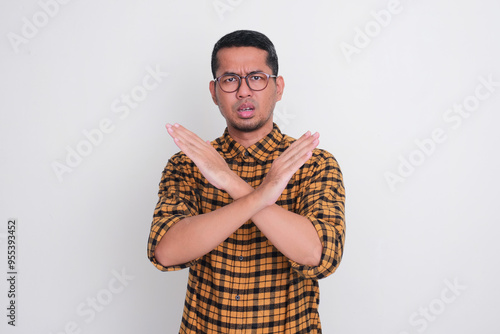 A man doing cross hand sign and showing worried expression photo