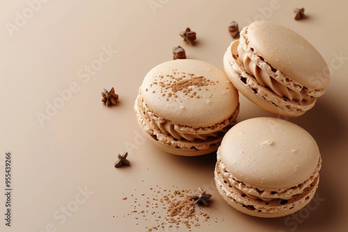 Light and airy spiced vanilla macarons, perfectly paired with a smooth and creamy filling, presented with a touch of star anise for a flavorful experience.