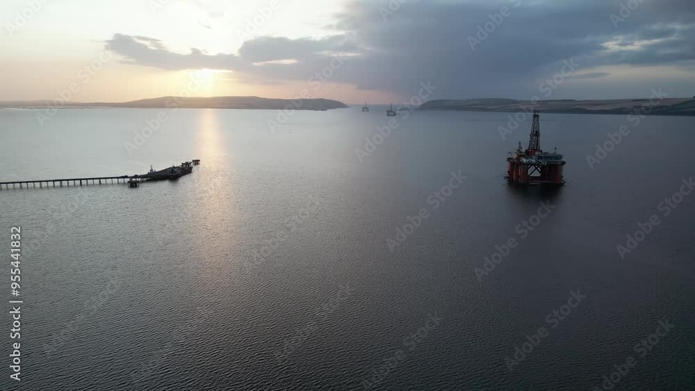 forward aerial view oil gas drilling rigs sunrise, parked sea harbor ...