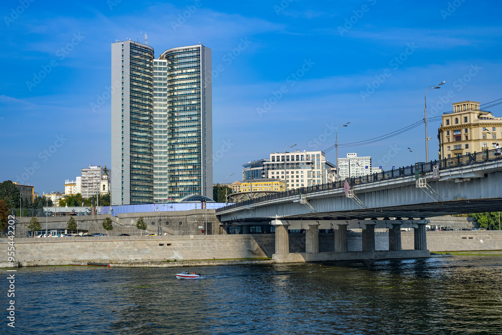 The building of the Council of Mutual Economic Assistance and the Novoarbatsky Bridge across the Moskva River on a sunny summer day The building of the Council of Mutual Economic Assistance and the Novoarbatsky Bridge across the Moskva River on a sunny summer day