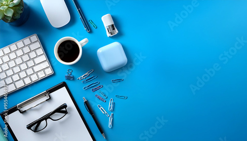 Organized office desk with business supplies and technology on a clean blue background. 