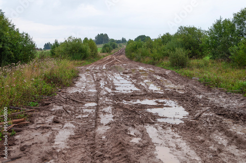 Valokuva Country landscape, messy dirt road with puddles after rain, Kostroma region, Rus