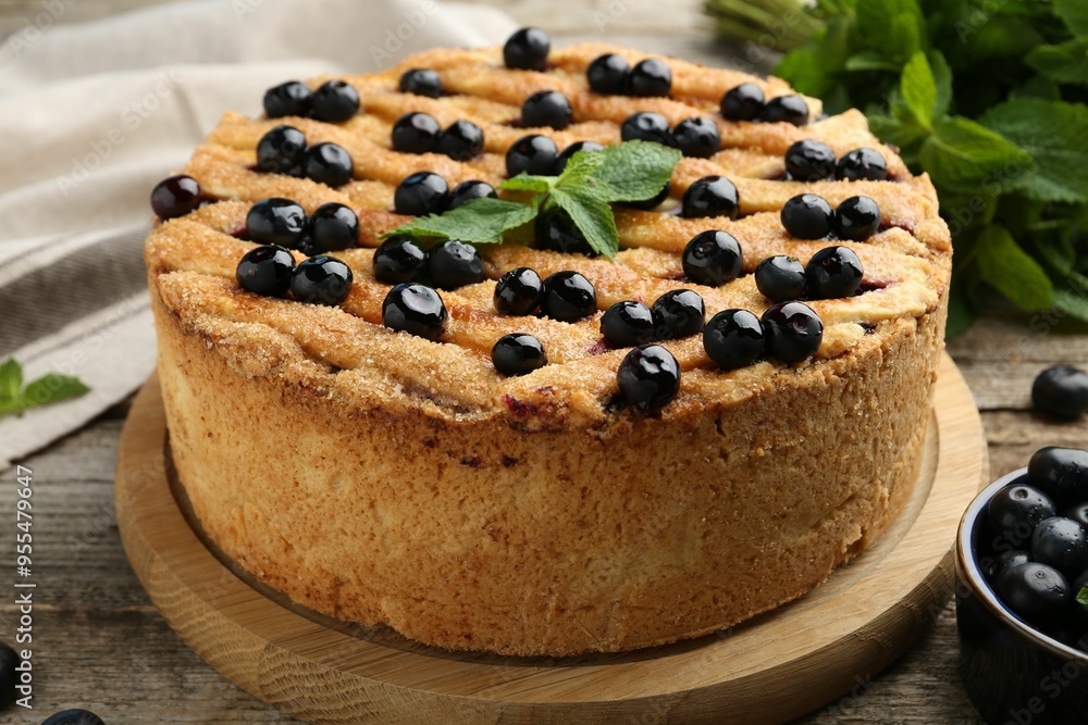 Delicious homemade blueberry pie with mint and fresh berries on wooden table, closeup Delicious homemade blueberry pie with mint and fresh berries on wooden table, closeup