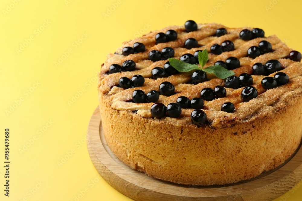 Delicious homemade blueberry pie with mint on yellow background, closeup Delicious homemade blueberry pie with mint on yellow background, closeup