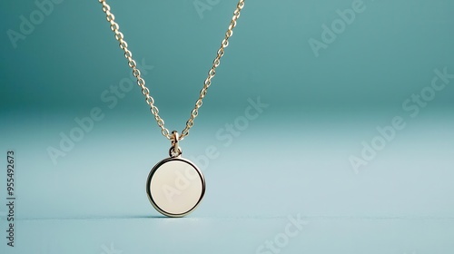 A minimalistic necklace with a tiny engraved charm, close-up, soft lighting, neutral background