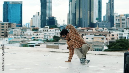 Professional hispanic break dancer practice B boy dance while multicultural friends at roof top. Young modern dancing group doing hip hop movement. Style,fashion,action. Outdoor sport 2024. Hiphop.