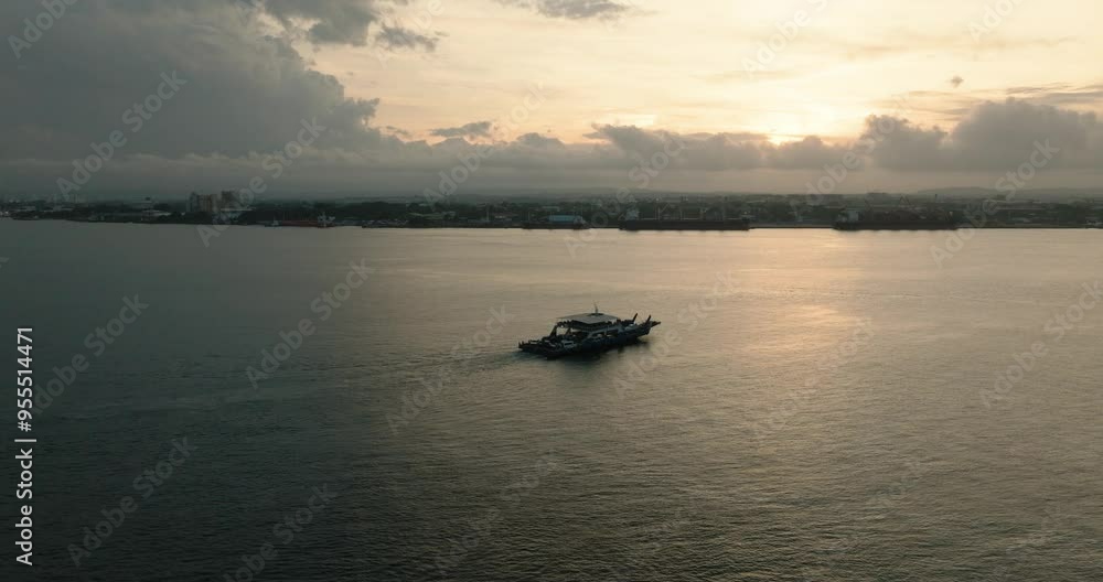 Aerial view of passenger boat and seaport in Davao over the cloudy sunset. Philippines. Aerial view of passenger boat and seaport in Davao over the cloudy sunset. Philippines.