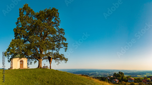 Alpine summer morning view with an old oak tree beside the famous Luitpold-chapel at Samerberg, Rosenheim, Bavaria, Germany photo