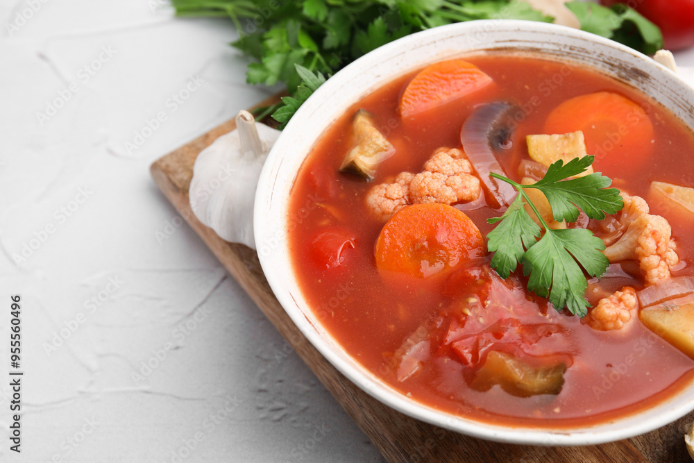 Delicious homemade stew in bowl on light table, closeup Delicious homemade stew in bowl on light table, closeup