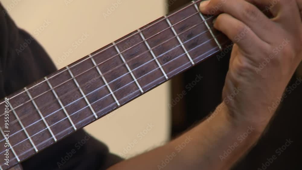 Serene Home Scene: Man with Classical Guitar Indoors - Close Up Serene Home Scene: Man with Classical Guitar Indoors - Close Up