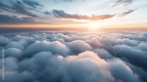 An inspiring scene of the sun rising above a blanket of fluffy clouds, casting a radiant light across the horizon and evoking feelings of hope, new beginnings, and tranquility.