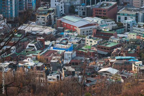 Beautiful vibrant aerial sunset view of Seoul, South Korea skyline, with mountains and sprin scenery beyond the city, seen from observation deck of Namsan Park, Gyeonggi-do province, Republic of Korea photo