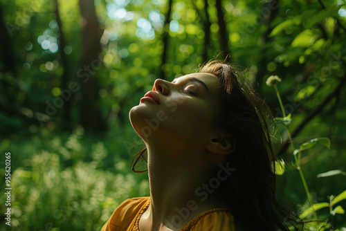 Beautiful young woman enjoying nature in a forest