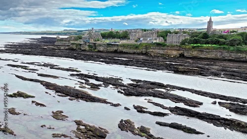 Aerial view of Coastal, episcopal castle ruins with secret passages and dungeon in Scotland. St Andrews Castle residence of Scotland's leading bishop, cathedral and town of St Andrews view. photo