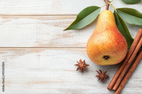 Pear, Cinnamon, and Star Anise on a White Wooden Background