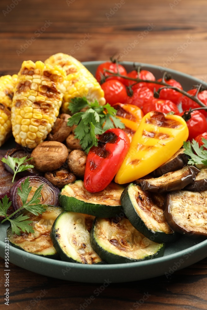 Delicious grilled vegetables on wooden table, closeup Delicious grilled vegetables on wooden table, closeup