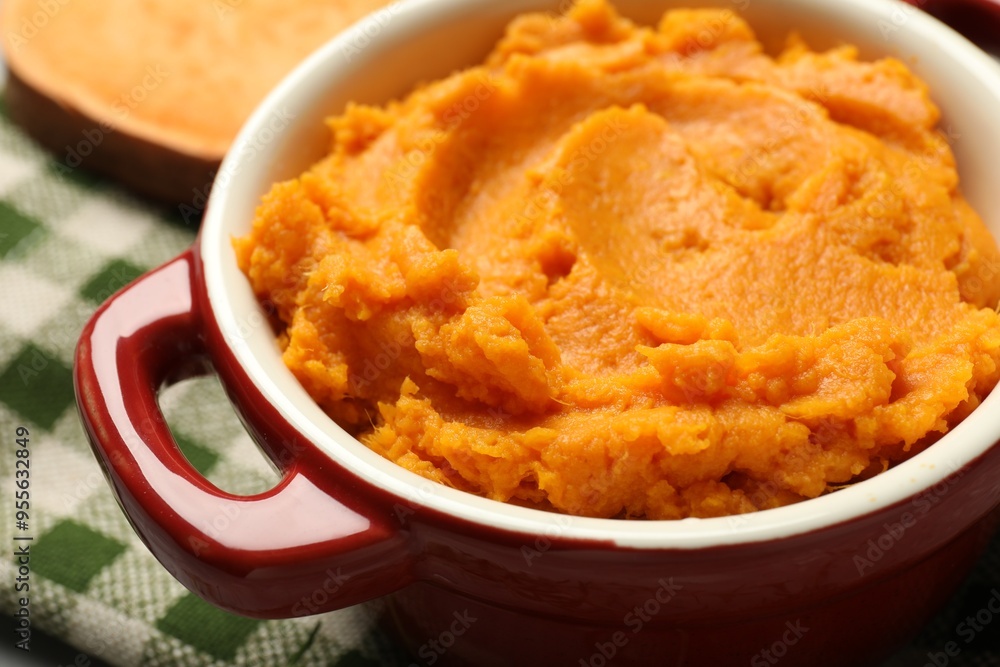 Delicious mashed sweet potatoes in pot on table, closeup Delicious mashed sweet potatoes in pot on table, closeup