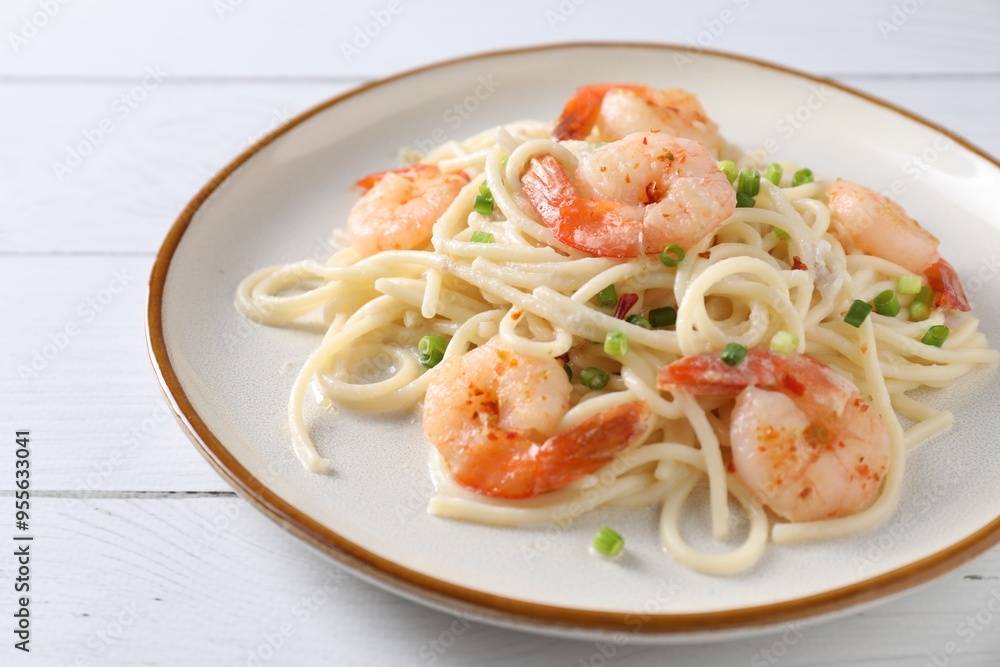 Delicious pasta with shrimps and green onion on white wooden table, closeup Delicious pasta with shrimps and green onion on white wooden table, closeup