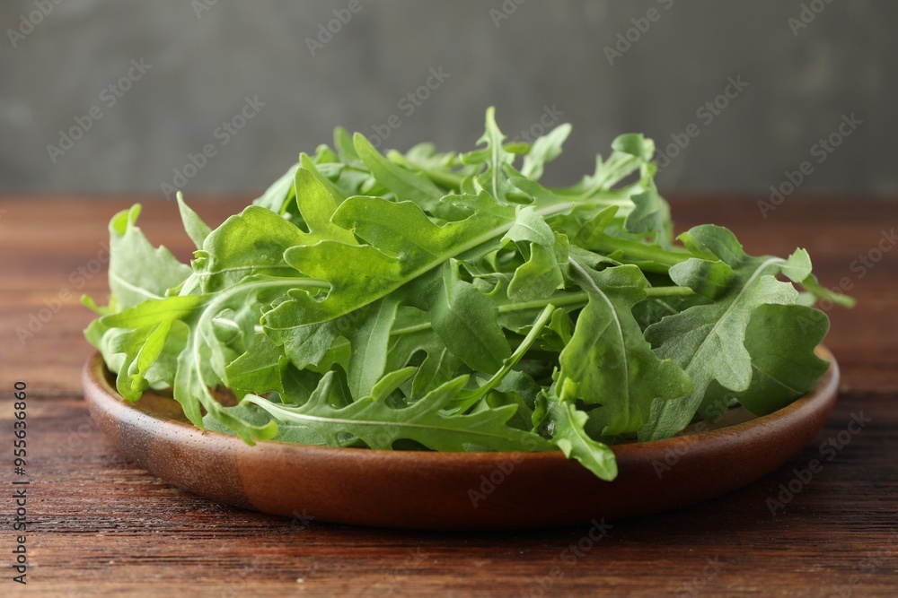 Fresh green arugula leaves on wooden table, closeup Fresh green arugula leaves on wooden table, closeup