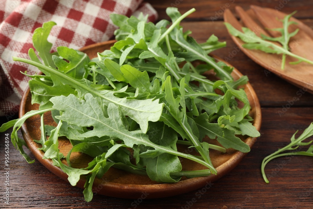Fresh green arugula leaves on wooden table, closeup Fresh green arugula leaves on wooden table, closeup