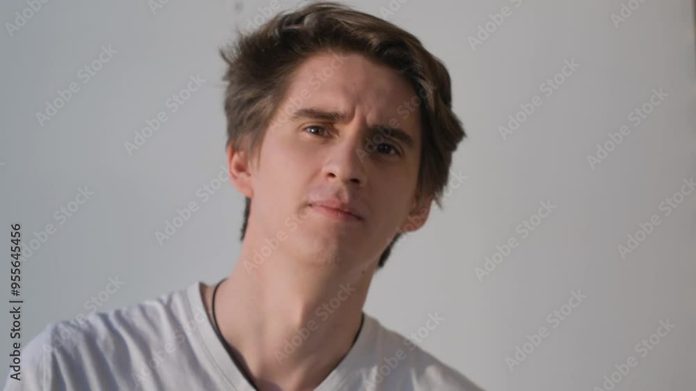 Irritated young guy shouts and swears and shakes his hand pointing with his finger Irritated young guy shouts and swears and shakes his hand pointing with his finger