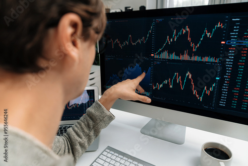 Smart stock investors pointing interesting market stock exchange on pc with laptop screen. Financial technology dynamic investment plan focusing data graph on monitor at modern workplace. Pecuniary.