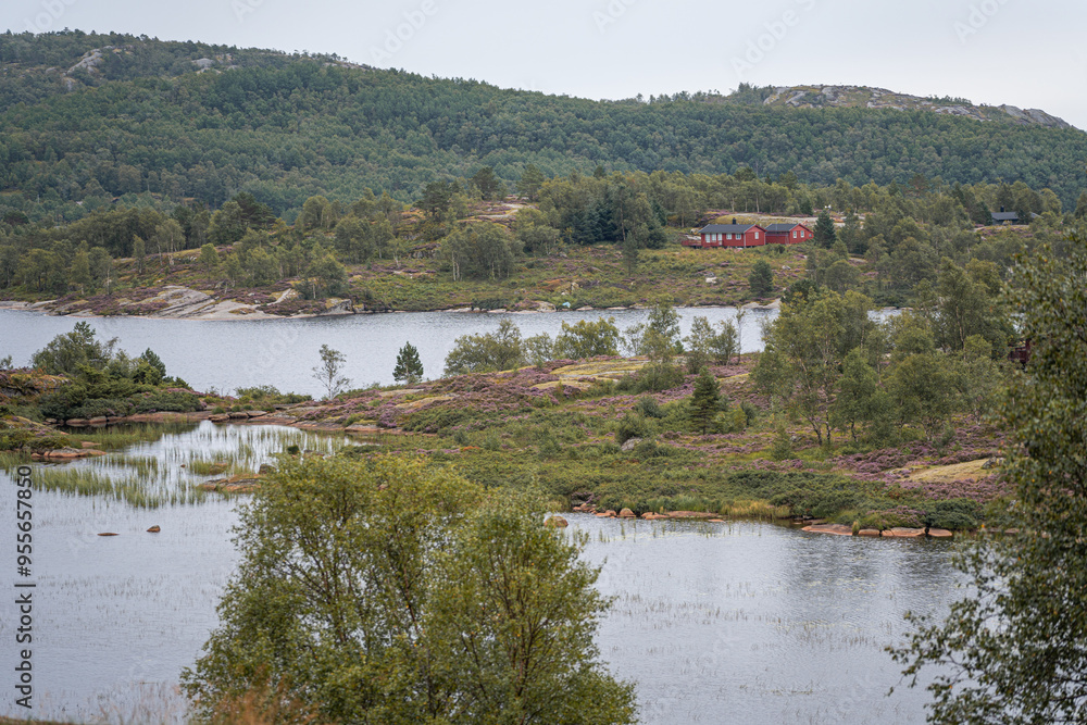 Norwegian lake landscape with lakes and red house in background Norwegian lake landscape with lakes and red house in background