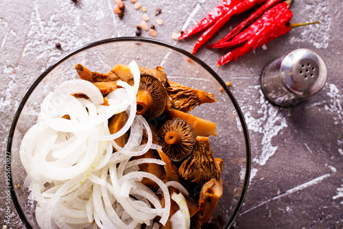 Marinated mushrooms in a glass bowl photo