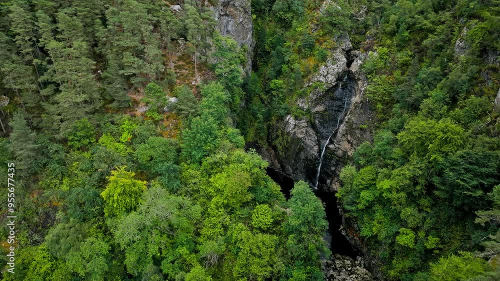 Scenic aerial view of Falls of Foyers with walking trails to a picturesque waterfall amid a lush, green landscape. Drone view of spectacular waterfall with stunning woodland on Scottish Highlands. Scenic aerial view of Falls of Foyers with walking trails to a picturesque waterfall amid a lush, green landscape. Drone view of spectacular waterfall with stunning woodland on Scottish Highlands.